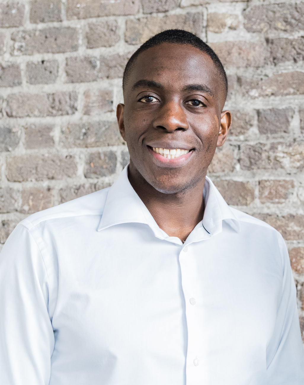 African businessman sitting down smiling